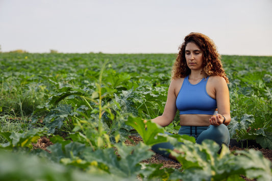A woman mediating in a field