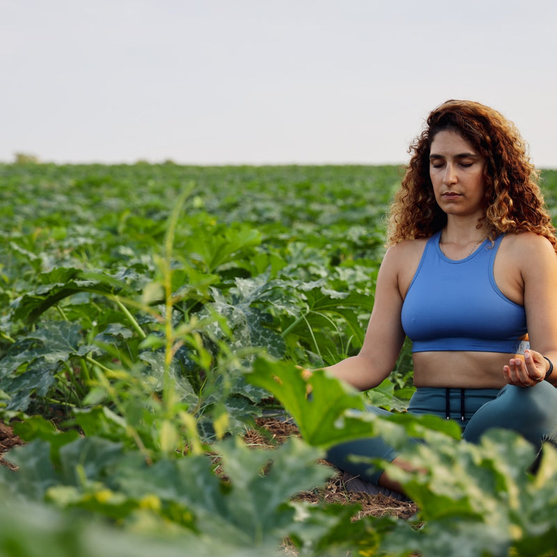 A woman mediating in a field 